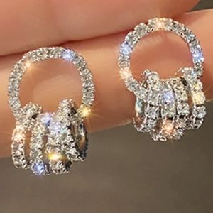 WHITE GOLD/ STERLING ENCRUSTED WITH WHITE TOPAZ CIRCLE AND CIRCLE EARRINGS 1 IN